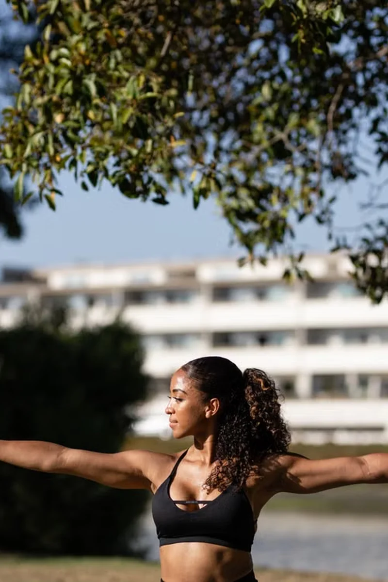 Woman wearing black yoga activewear outdoors
